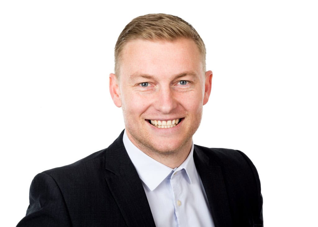 Darren Brooks, Head of Technical and Design at Premier Modular building company. Man with short blonde hair, wearing a suit. 